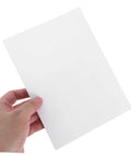 Hand holding a vinyl patch from the 12 Piece Vinyl Patch Kit For Wall Repair Self Adhesive Patches For Cracks Holes And Blemishes Quick Install