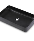 Rectangular black porcelain vessel sink, sleek above counter design, ideal for modern bathrooms, 24 by 14 inch durable ceramic basin.