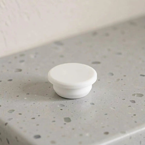 5pcs Silicone Bathtub Jet Cover Plug for 30-31mm Round Holes on a gray countertop, highlighting its smooth surface.