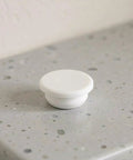 5pcs Silicone Bathtub Drain Stopper Cover for 30-31mm Holes White on a countertop, featuring a circular design and smooth surface.