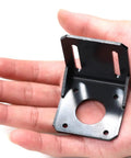 Hand holding a Two Pack 42mm Nema 17 Stepper Motor Mounting Brackets Alloy Steel L Shaped Mounting Brackets Fixed Base For CNC DIY Robots Durable Steel Construction Easy Install And Strong Mounting In Tight Spaces.