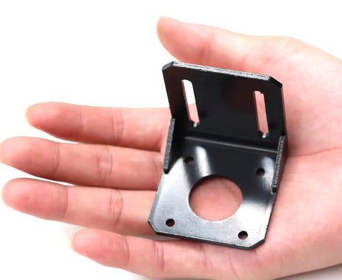 Hand holding a Two Pack 42mm Nema 17 Stepper Motor Mounting Brackets Alloy Steel L Shaped Mounting Brackets Fixed Base For CNC DIY Robots Durable Steel Construction Easy Install And Strong Mounting In Tight Spaces.