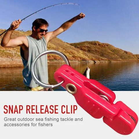 Pink plastic snap release clip for planer board fishing with metal ring, shown in foreground.