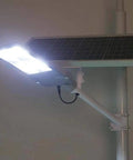 JUDYSSY Solar Floodlights,Led Street Light mounted on a pole with a solar panel, providing bright illumination.
