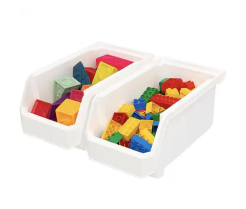 Set Of Six Crisp White Stackable Storage Bins Featuring Lockdown Grip Base And Crystal Clear Front Panels To Kick Pantry Chaos To The Curb And Tame Craft Tables filled with colorful building blocks.