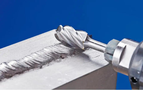 Close-up of a carbide bur cutting aluminum, demonstrating the Five Piece Carbide Bur Set With One Quarter Inch Shank In Durable Plastic Case Optimized For Aluminum And Non Ferrous Metals Beefy Stock Removal High Performance Cutting Burs For Fast Metal Shaping And Detailing in action.