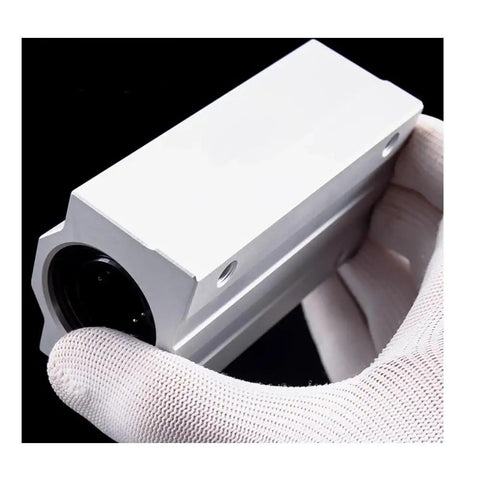 Top Shelf Linear Ball Bearing Block Slide Unit For CNC Router And 3D Printer Shaft Rods with aluminum casing held in a gloved hand.