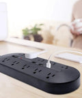 10 Outlet Power Strip With USB Ports And 1700J Surge Protector For Dorms And Offices on desk with USB cable connected