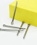 304 Stainless Steel Cotter Pin Set Kit With M1.5 To M6 Sizes, close-up of cotter pins on yellow surface for heavy duty machinery