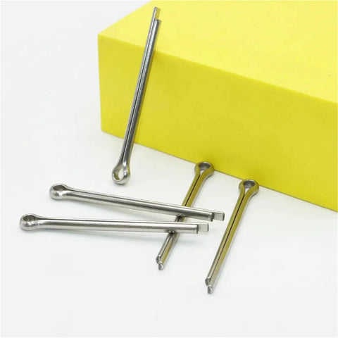 304 Stainless Steel Cotter Pin Set Kit With M1.5 To M6 Sizes, close-up of cotter pins on yellow surface for heavy duty machinery
