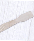 Close-up of a metal scraper from a Two Piece Tin Paste Mixing Tablet Clamshell Tool Set, Pro Grade Ergonomic Grip, bright silver finish.