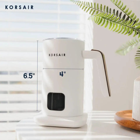 Electric Milk Frother 4 In 1 for Hot and Cold Foam One Touch Automatic Milk Steamer and Warmer Machine in white on a table.