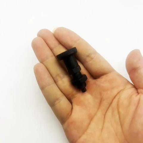 Badass Black Rustproof Steel 2 Pack Knob Plunger Pins M10 held in hand, showcasing smooth sliding action and heavy duty design.