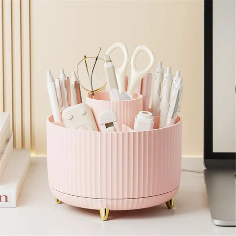Rotating Desk Organizer With Six Compartments For Pens, Markers, Art Supplies And Makeup Tools, 360 Degree Spin Office Storage That Keeps Desk Clutter Under Control, Great For Home Office, Dorm, Nightstand Or Dresser. Pink plastic desk organizer with six compartments on gold feet, filled with pens and scissors.