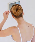 Using Solid Ball Tipped Hair Pins 320 Count Brown Crimped Styling Clips to secure a smooth bun hairstyle.