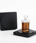360 Degree Motorized Rotating Display Stand For Photography Products showcasing a whiskey decanter on a sleek black platform.