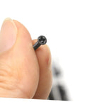Solid Gear Carbon Steel Miniature Screw Assortment Loaded With Round Head Countersunk Bolts Inside A Compact Travel Kit For Hassle Free Notebook Glasses Repairs, close-up of a black countersunk screw.