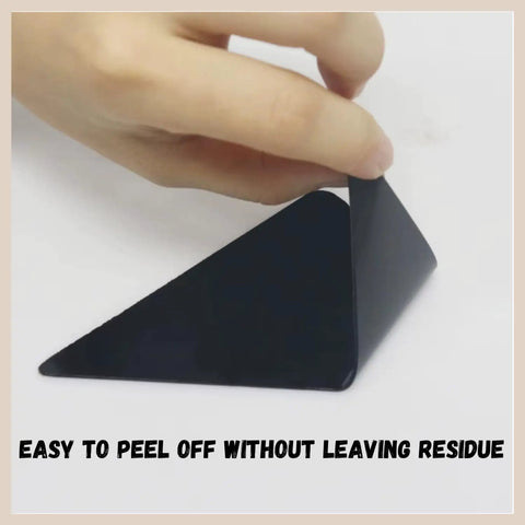 Hand peels triangle-shaped 16 Pack Non Slip Rug Tape For Hardwood Floors And Tiles Double Sided Reusable Gripper Pads.