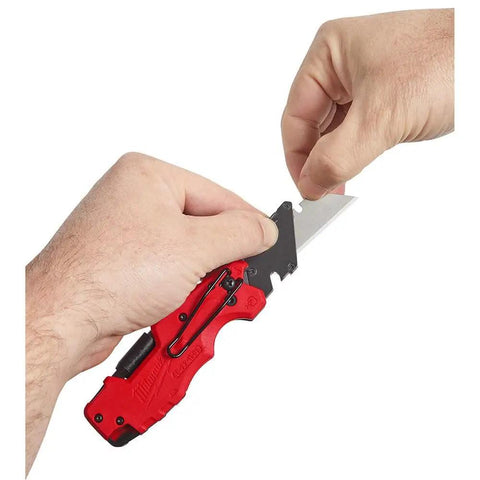 Fastback Compact Folding Knife Set Two Pack Red And Black Six In One Folding Utility Knives in hand, showing metal blade and handle.