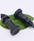 Heavy Duty Bad Boy Grade Carbon Steel Self Locking Ball Nose Spring Plunger Kit With Knurled Lock Nut For No Sweat Positioning And Rock Solid Industrial Fixing M10 on green leaf background.