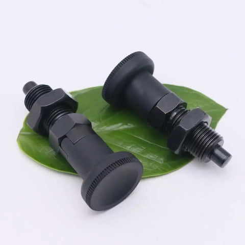 Heavy Duty Bad Boy Grade Carbon Steel Self Locking Ball Nose Spring Plunger Kit With Knurled Lock Nut For No Sweat Positioning And Rock Solid Industrial Fixing M10 on green leaf background.