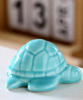 Heckin Adorable Ceramic Sea Turtle Toilet Bolt Caps Set Of 2 Snazzy Screw Cover in light blue, decorative bathroom accessory.