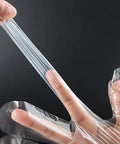 Clear disposable food-prep gloves; transparent plastic being stretched between fingers