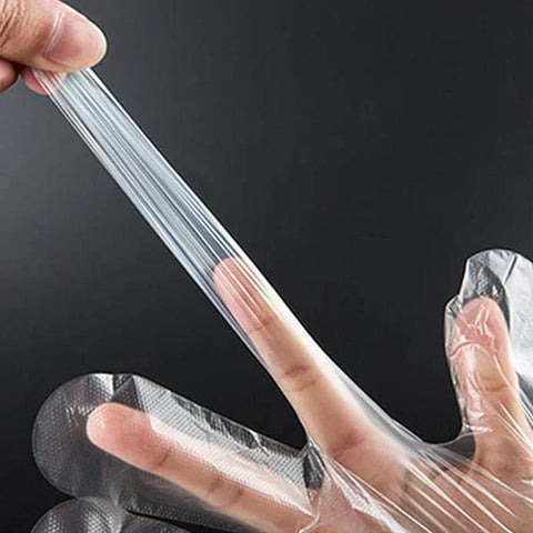 Clear disposable food-prep gloves; transparent plastic being stretched between fingers
