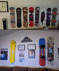 Beefy Ski And Snowboard Wall Mount Storage Rack Invisible Floating Garage Display Organizer securely holds colorful boards on a wall.