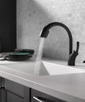 Matte Black Kitchen Faucet With Mid-Rise Pull-Out Sprayer For Single-Hole Install on marble sink with running water