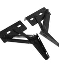Close-up of two black metal folding sofa hinges with springs for space-saving furniture storage.