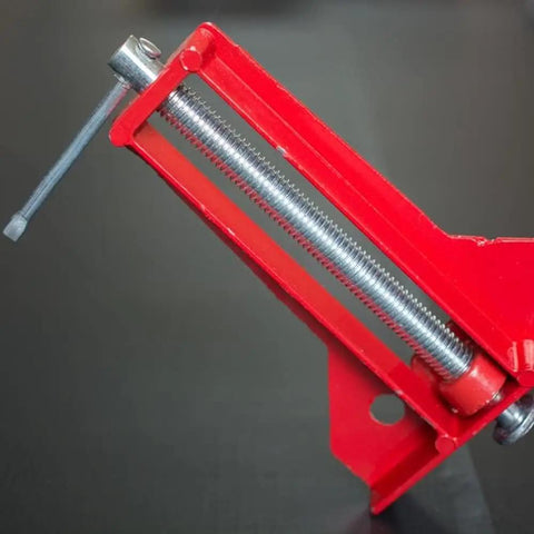 Close-up of Pro Grade 90 Degree Corner Clamps for Woodworking, showing red metal L-shaped jaw and adjustment handle.