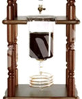 Top Shelf Stainless Steel Cold Brew Dripper With Heavy Duty Premium Borosilicate Glass For Smooth Iced Coffee Sipping And Solid Morning Percolation Routine on wooden stand.