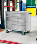 Top Shelf 9 Drawer Stainless Steel Tool Cabinet Rock Solid Rolling Chest Premium 304 Build shown in workshop setting.