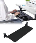 Hella Sturdy Under Desk Keyboard And Mouse Tray Pull Out Sliding Platform With Secure C Clamp Mount System Instant Install Height Adjustable For Ergonomic Workstation, black tray shown in use with keyboard and mouse.