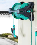 Pretty Slick Portable Garden Hose Reel With High Pressure Water Gun, wall-mounted storage with green hose and spray nozzle.