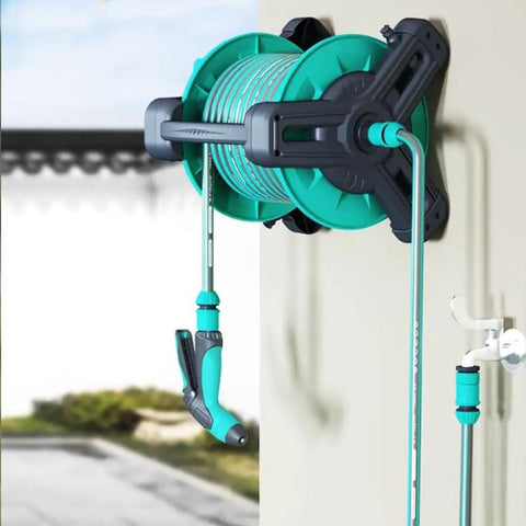 Pretty Slick Portable Garden Hose Reel With High Pressure Water Gun, wall-mounted storage with green hose and spray nozzle.