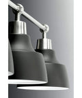 Close-up of Bramlett Bath And Vanity Light in Nickel Finish with vintage industrial style black shades.