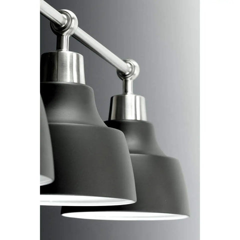 Close-up of Bramlett Bath And Vanity Light in Nickel Finish with vintage industrial style black shades.