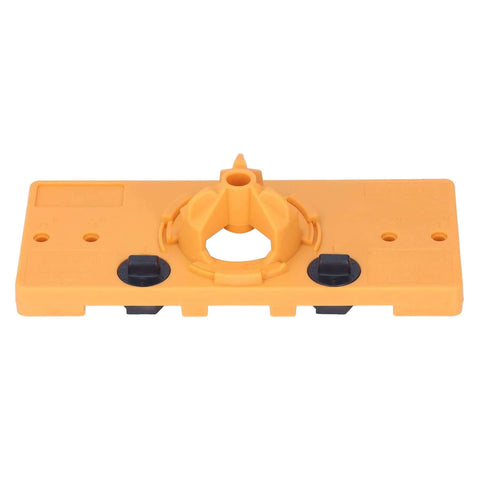 Front view of orange 35mm hinge hole jig base for cabinet doors; central circular guide and black clamps.