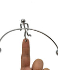 Balance Physics Desk Toy Kinetic Weightlifter Steel Man Figure balancing on finger demonstrating Newtonian tumbler design