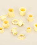 8mm ID 10mm OD Flanged Sleeve Bearing Kit POM Plastic Bushing 15mm Length Yellow 8 Pack scattered on a surface