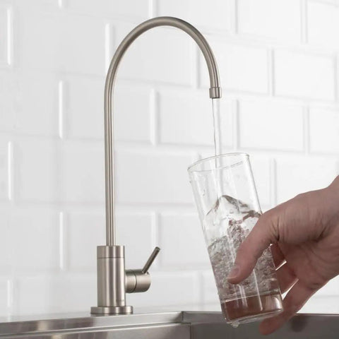 Purita No Lead Kitchen Water Filter Faucet With Spot Free Stainless Steel Finish Stand Alone Beverage Faucet running water into a glass