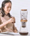 Top Shelf 800 Milliliter Glass Ice Drip Cold Brew Coffee Maker With Smooth Flow Filter Carafe on a table with ice.