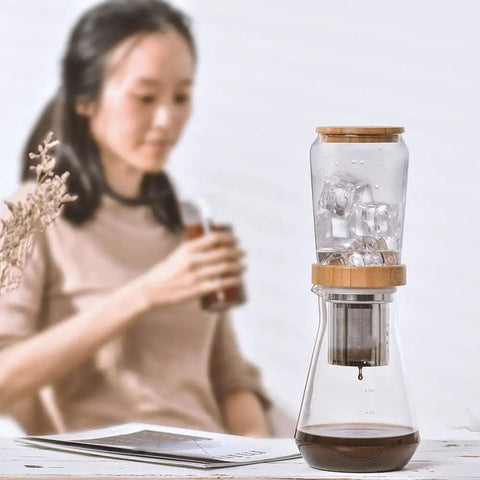 Top Shelf 800 Milliliter Glass Ice Drip Cold Brew Coffee Maker With Smooth Flow Filter Carafe on a table with ice.