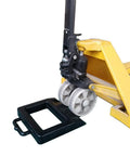 Rubber Pallet Jack Chock Heavy Duty Wheel Stopper for Pallet Jacks and Trucks stabilizes wheels, black, shown with yellow pallet jack