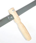 Close-up of S-shaped wooden handle of Traditional Scythe With 23.2 Inch Blade And S Shaped Wooden Handle For Grass And Grain Cutting 65 Manganese Steel Garden Tool Manual Yard Work And Field Maintenance.