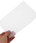 Hand holding one sheet of Boss Grade Flower Wrapping Paper Kit 200 Pieces 21x14 CM White Paper For Florists Writable Surface