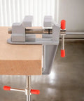 Compact Table Vise For DIY Projects And Home Repairs, Handy Bench Clamp For Woodworking On Your Workbench Or Craft Desk, Lightweight Yet Sturdy Aluminum Vise With Adjustable Jaw And Portable Clamp shown mounted on a wood surface.