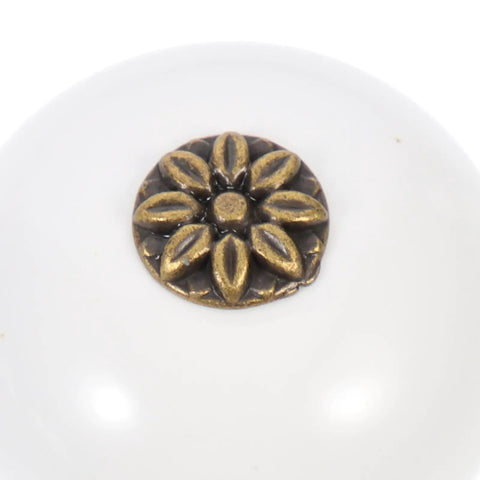 Close-up of white antique round door knob with floral design, part of Two Pack Single Hole Dresser Handles For Cabinets And Drawers White Antique Round Door Knobs For Wardrobes And Bathrooms Classic Cabinet Hardware Upgrade For Furniture And Home Decor.